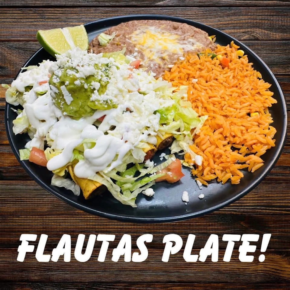 A flautas plate with rice, refried beans, guacamole, sour cream, lettuce, and cheese.